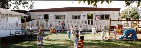 Original classrooms with ramp for handicap access.  White building at left is Original Family Room.